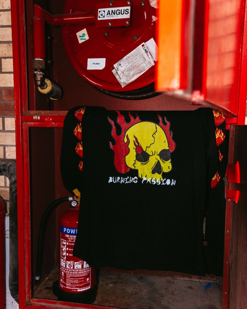 BURNING PASSION Longsleeve T-Shirt featuring a yellow skull with flames, burning hearts on the sleeves, and a fiery font. Express your unstoppable passion