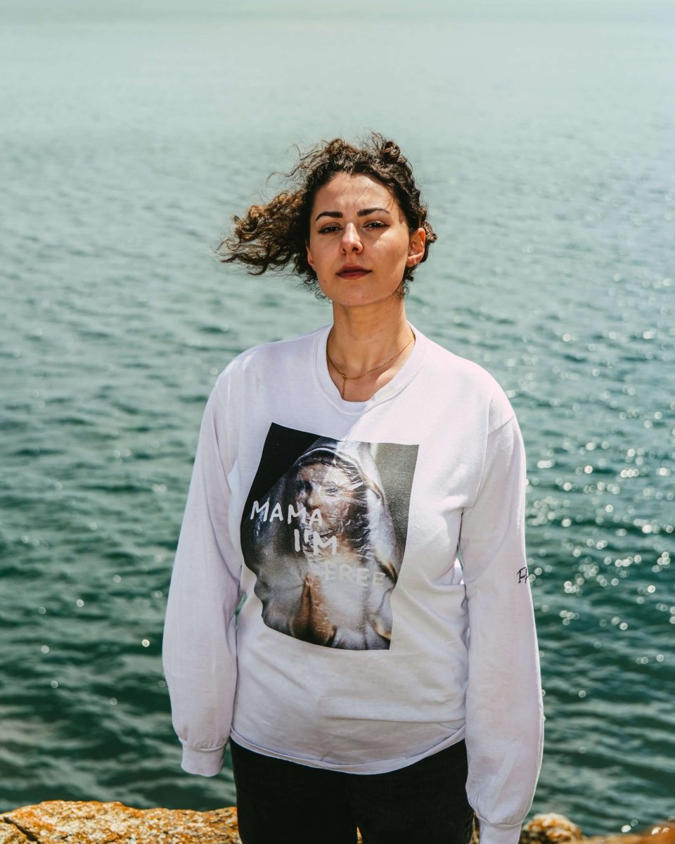 MAMA I’M FREE spiritual freedom graphic long sleeve featuring a praying nun with "MAMA I’M FREE" painted in white, symbolizing liberation