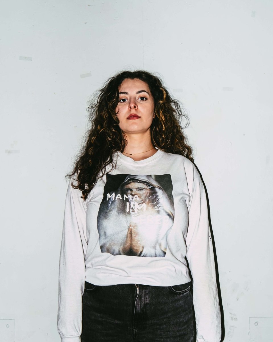 MAMA I’M FREE spiritual freedom graphic long sleeve featuring a praying nun with "MAMA I’M FREE" painted in white, symbolizing liberation