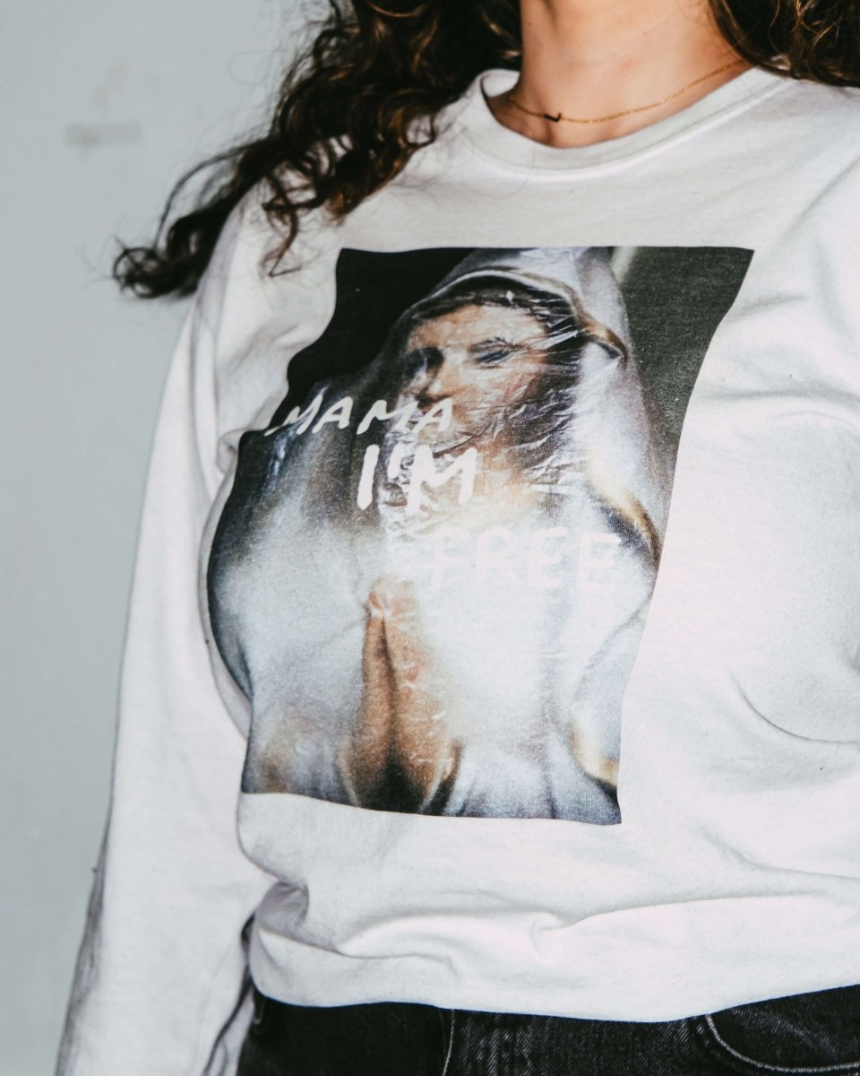 MAMA I’M FREE spiritual freedom graphic long sleeve featuring a praying nun with "MAMA I’M FREE" painted in white, symbolizing liberation